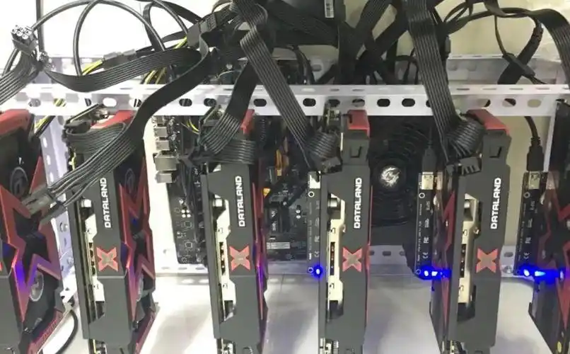 A miner inspecting his mining rig in a mining farm