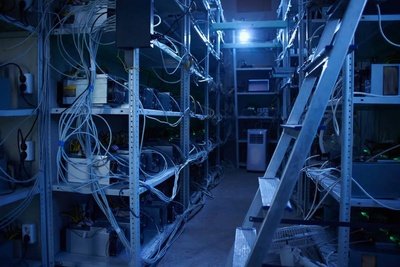 A picture of a mining farm with several mining rigs running
